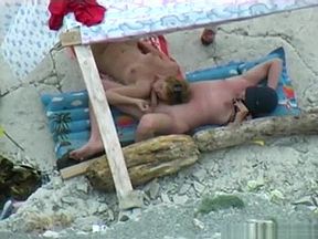 Voyeur tapes a nudist couple having oral sex at the beach