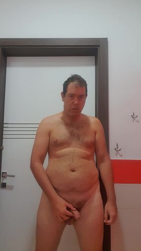 A boy completely naked in a station bathroom
