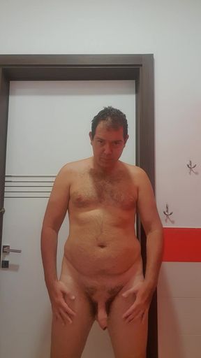 A boy completely naked in a station bathroom