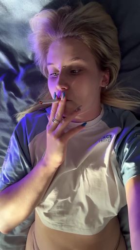 Dirty blonde MILF shows off big natural tits while smoking