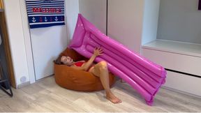 Nastya inflates a swimming mattress and shakes her butt on it
