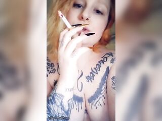Redhead looks at u during the time that smokin' a cigar