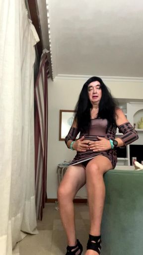 Beautiful and sexy Spanish trans woman poses and masturbates in the living room wearing a tight miniskirt and high heels, anal
