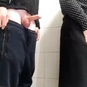 Gorgeous MILF jerks me off in a public toilet