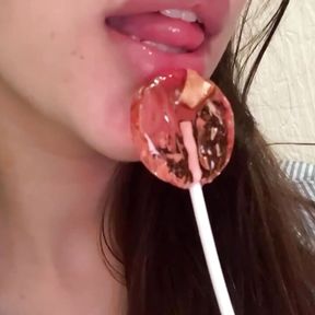 This lustful bitch sucks candy and dreams of a big dick