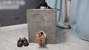 GG96-A cute barefoot Asian girl is bound inside a box, her feet sticking out from a hole and tied together. Let's tickle these beautiful feet!