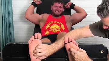 Hunky muscular dude endures tickling from m