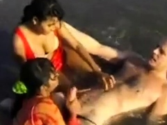 2 Indian girls with white guy in beach have fun blowjob..