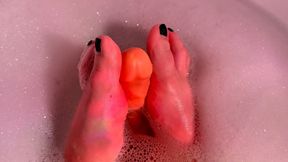 Feet play with dildo in bath