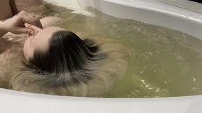 Playing with my hair making waves in bathtub
