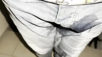 Twink pisses in jeans and jerks uncut cock outdoors