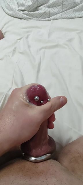 Pierced cock cumming with toy
