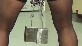 Mature redhead MILF endures needles and heavy weights in an intense BDSM