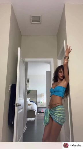 Tall and curvy woman in a blue bikini posing