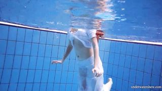Ginger Marketa inside a white dress into the pool