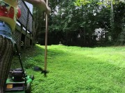 Big fake tits halter top Daisy Dukes wearing crossdresser cutting the grass
