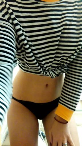 Daytime home striptease in a striped shirt. Close-up