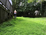 Big fake tits halter top Daisy Dukes wearing crossdresser cutting the grass