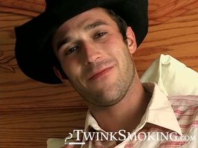 Hottie Cody lights his red cig while stroking his pinkish cock