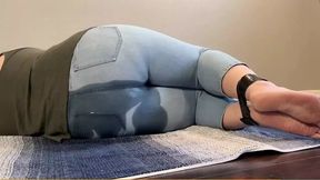 Tied up girl can't hold it anymore and pees in light jeans