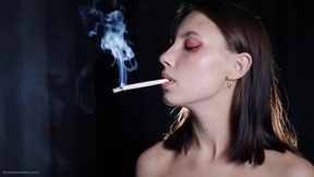 Elegant Brunette Smoking Cigarette in Dark Studio Scene