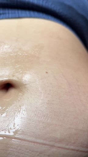 Playful girlfriend plays with her belly button
