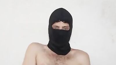 Perverted masked chap is playing with a condom in this solo video