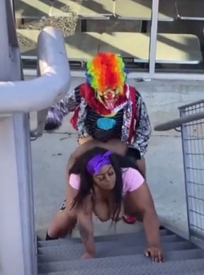 Clown and Woman on Stairs