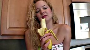 Naughty solo teen chewing on a banana