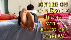 Ignore on the Bed in Jeans with Soles on Display