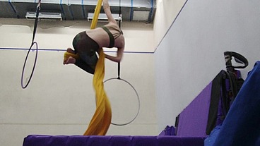 Practicing hip locks on the aerial silks