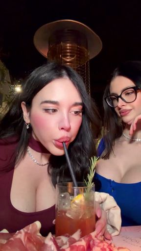 Woman drinking cocktail at bar