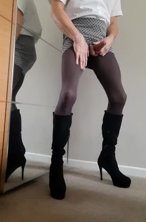 Sissy secretary wearing opaque tights, knee high boots, mini skirt whilst flashing cock