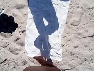 masked man having sex on the beach