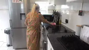 Naughty housewife cleaning in the kitchen