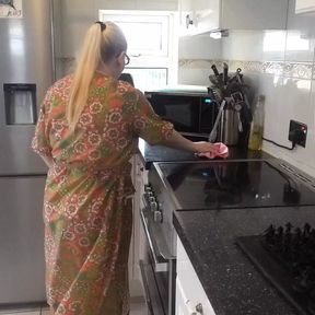 Naughty housewife cleaning in the kitchen