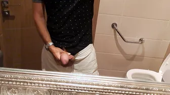 Hung French twink pumps his thick cock in public restroom