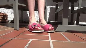 Shoe play, toe wiggling, wrinkled soles in the sun on the garden terrace