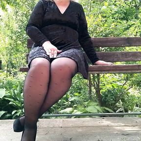 Naughty milf in pantyhose pissing in the park on a bench &ndash; rear view