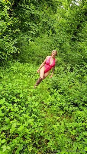 Woman in red bikini walking through tall grass
