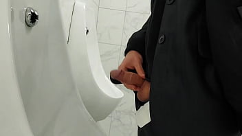 Young twink cruising up public male restroom at a local mall, hoping to catch some curious dicks
