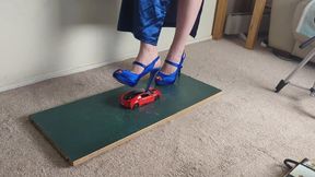 Giantess Lily Kink toy car crush of a 2017 BMW I8 in big blue heels Left view