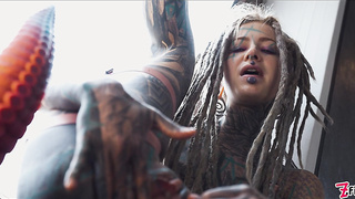 Fabulous tatted damsel pokes her bootie with a enormous fake penis
