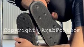 Footslave worships Arab Master's feet under the chair