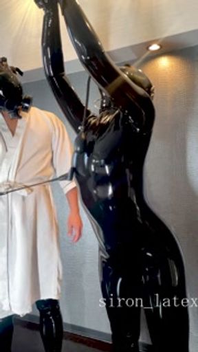 Lift the collar of the suspended latex doll and even more toys make her feel good