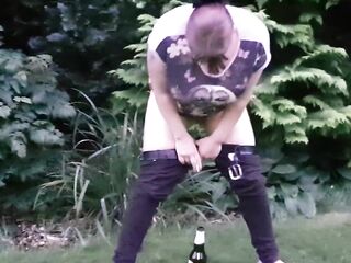pissing and screwing a bottle in the park