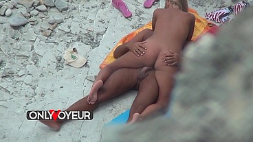 Beach Voyeur. Naked teen blonde soaks up the sun with her wealthy old man.