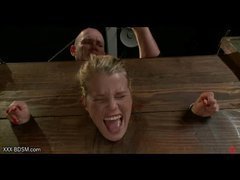 Blonde in wooden clamps gets pussy stimulation