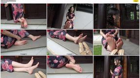 The aloof and wealthy heiress, Ren YingYing, sat on a bench, displaying her weathered, beautiful feet while wearing a long Chinese cheongsam. copy