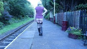 Crossdressed ooudoors on a public railway platform